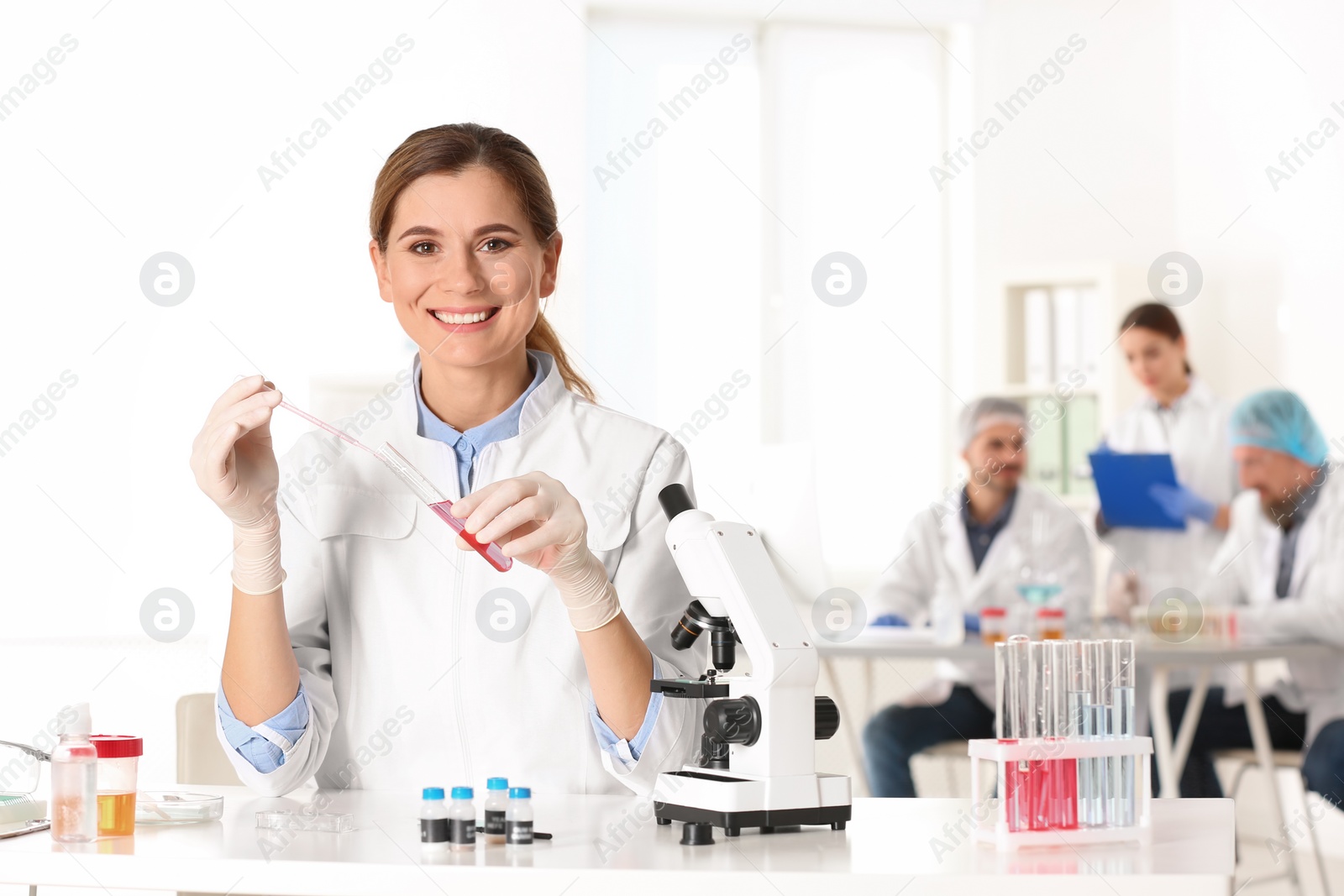 Photo of Portrait of female scientist working at table in laboratory, space for text. Research and analysis