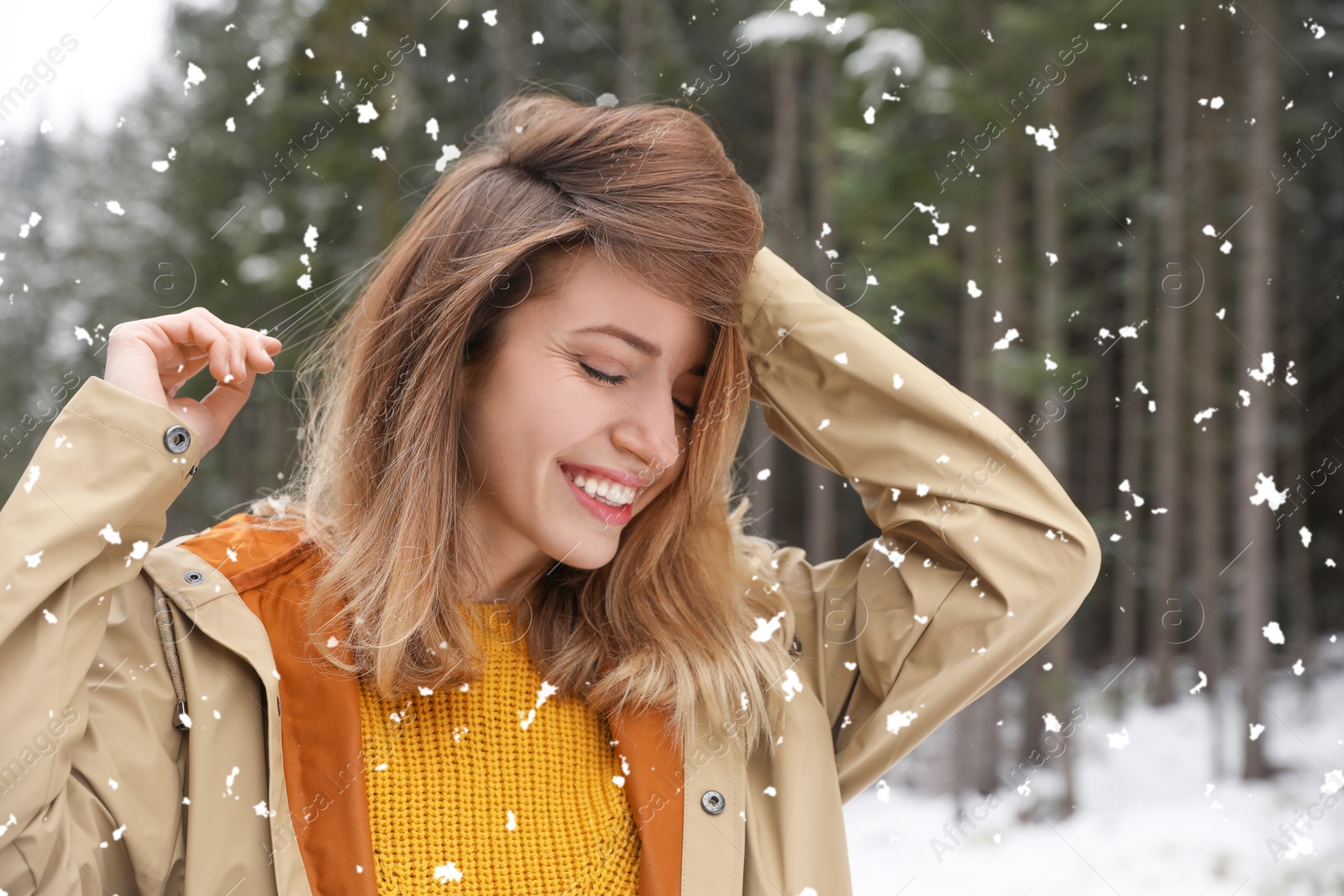 Photo of Young woman in warm clothes outdoors on snowy day. Winter vacation