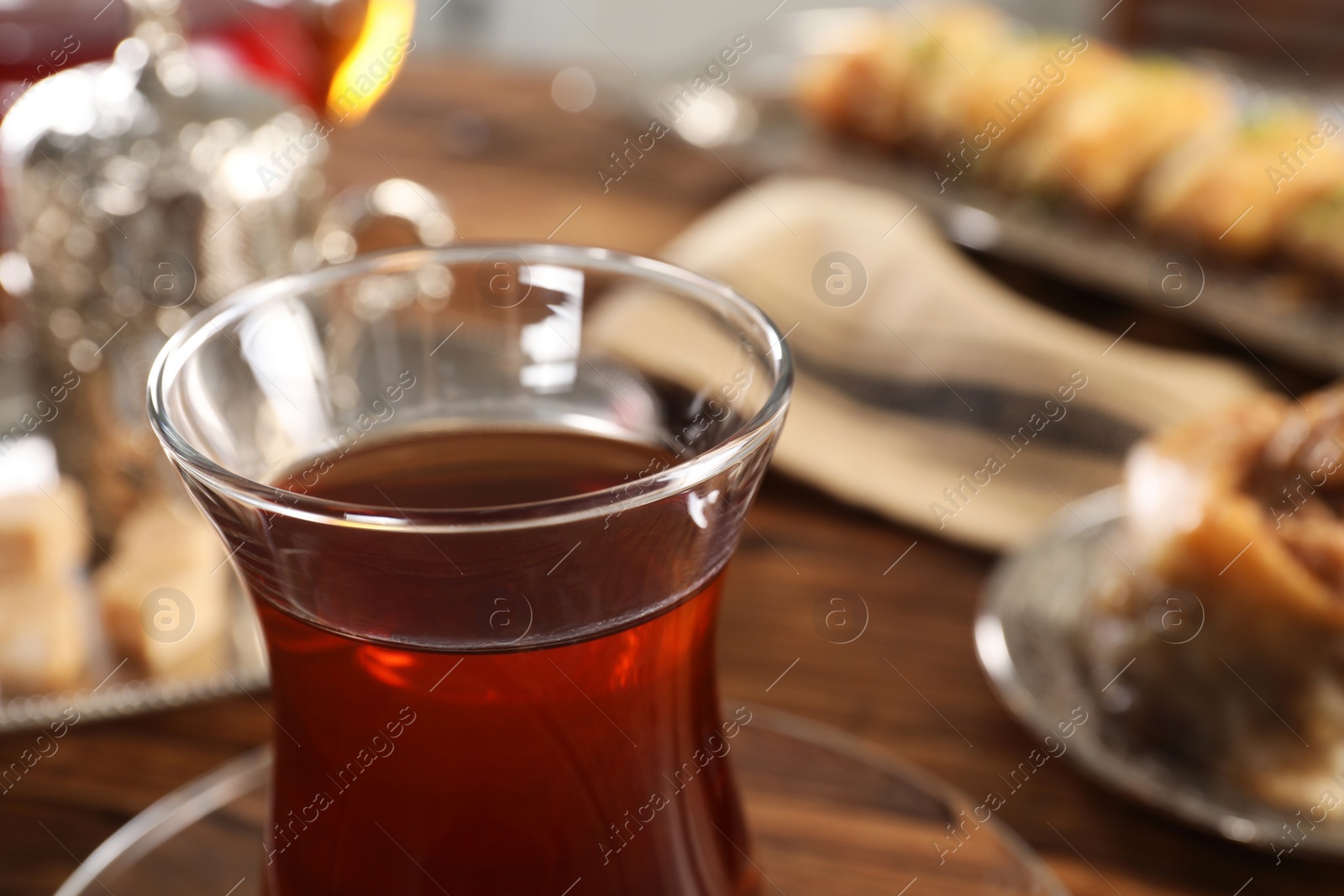 Photo of Traditional Turkish tea in glass on table, closeup. Space for text