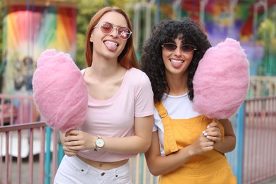 Photo of Happy friends with cotton candies at funfair