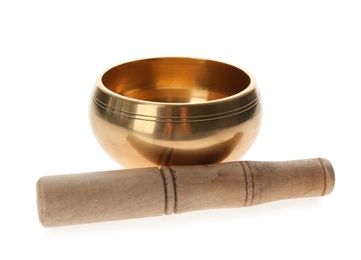 Photo of Golden singing bowl and mallet on white background.  Sound healing