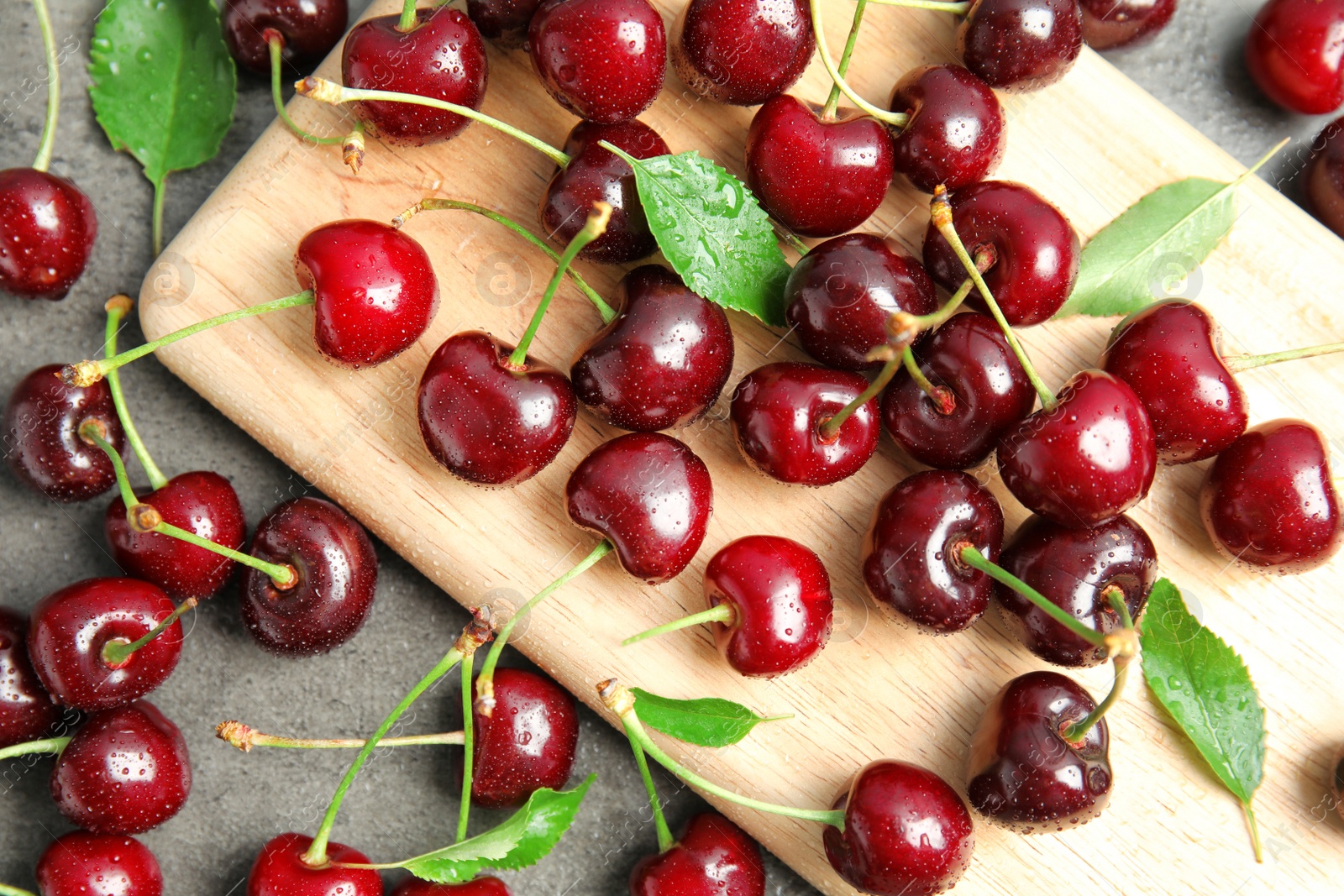 Photo of Sweet red cherries on wooden board, top view