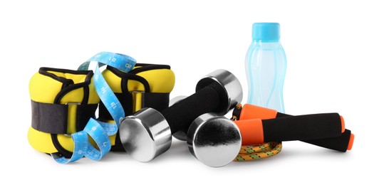 Photo of Dumbbells, water bottle, weights, skipping rope and measuring tape isolated on white
