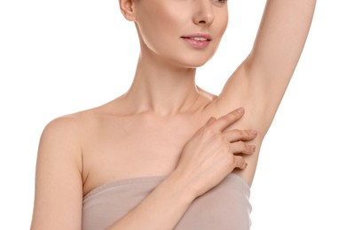 Woman showing armpit with smooth clean skin on white background, closeup