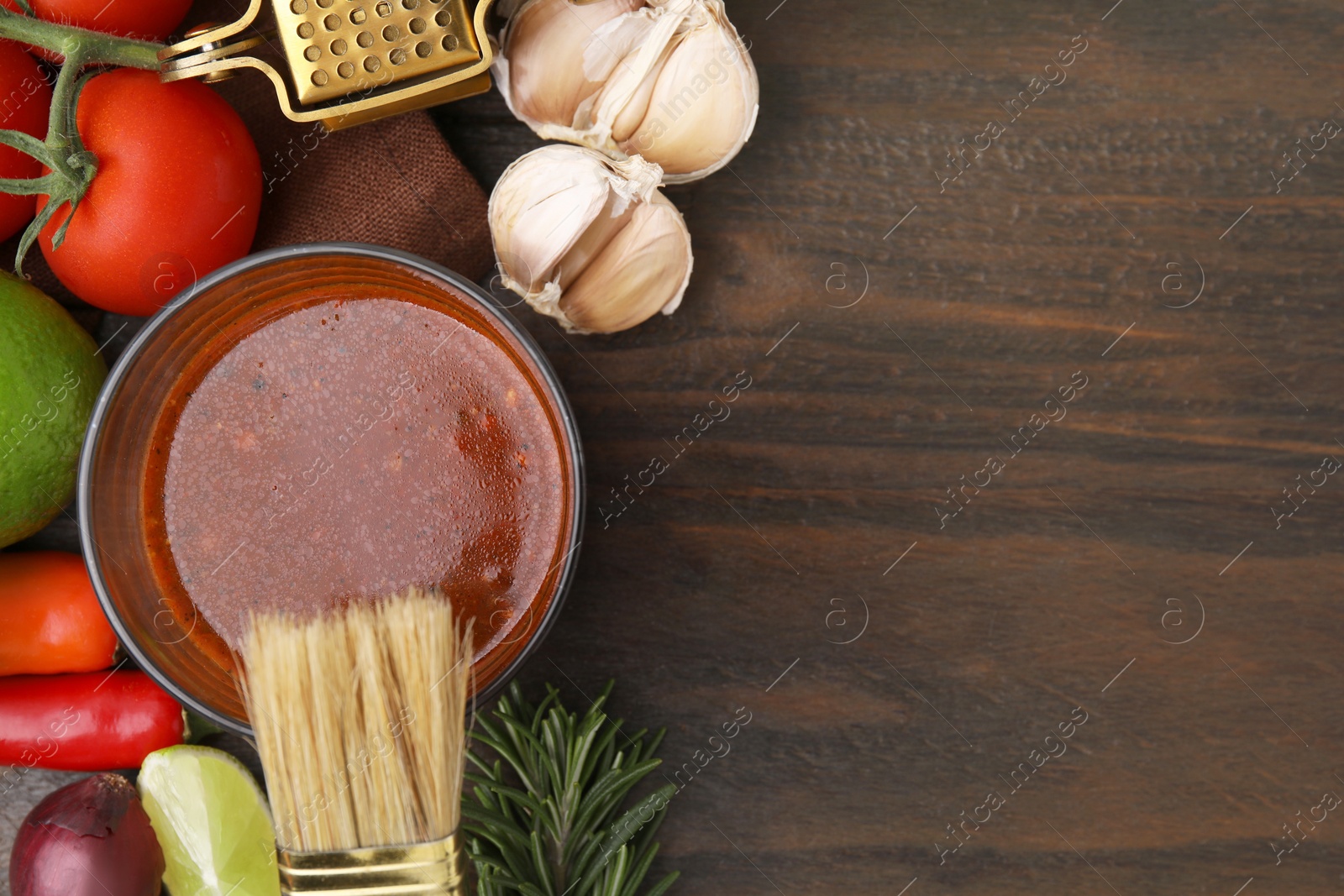 Photo of Tasty marinade and products on wooden table, flat lay. Space for text