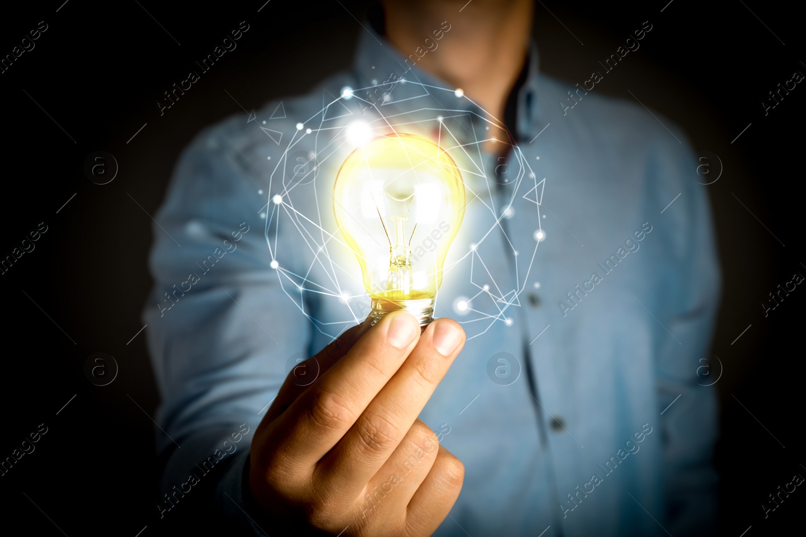 Image of Glow up your ideas. Man holding light bulb on black background, closeup