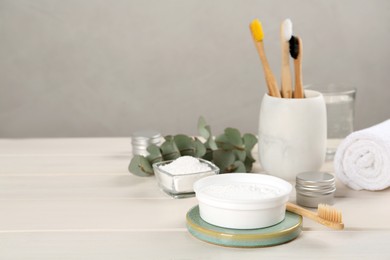 Photo of Composition with tooth powder on white wooden table, space for text