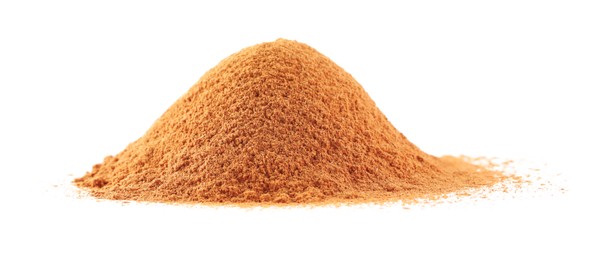 Photo of Pile of dry aromatic cinnamon powder isolated on white