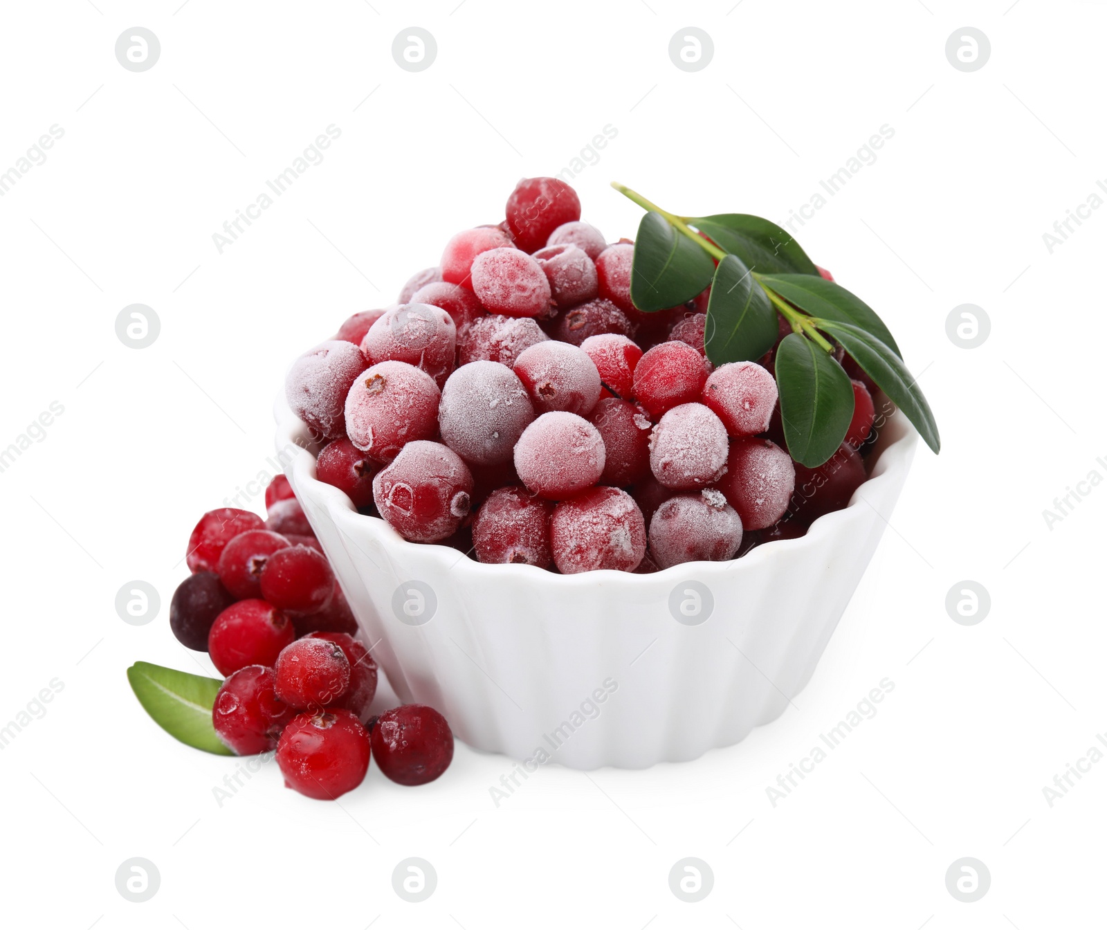 Photo of Frozen red cranberries in bowl and green leaves isolated on white