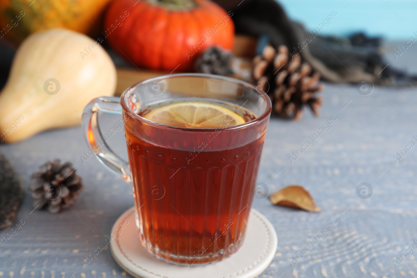 Photo of Cup of hot drink on grey wooden table. Cozy autumn atmosphere