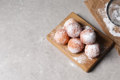 Photo of Delicious sweet buns with powdered sugar on gray table, above view. Space for text