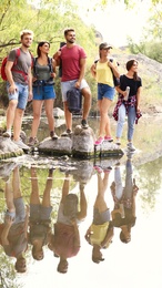 Group of friends hiking outdoors. Camping vacation