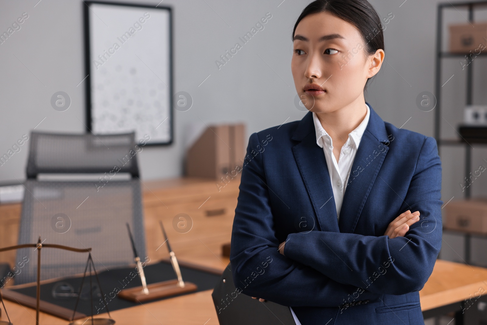 Photo of Portrait of notary with crossed arms in office. Space for text