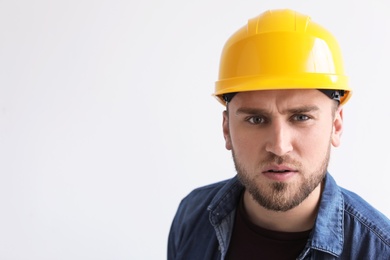 Photo of Young working man in hardhat on white background
