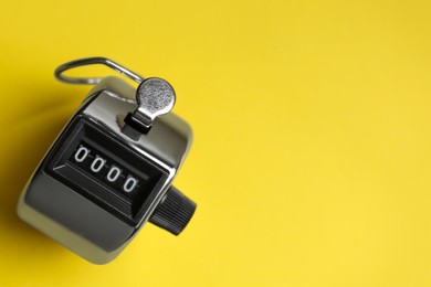 Photo of Modern timer on yellow background, top view. Space for text