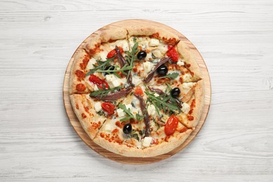 Tasty pizza with anchovies, arugula and olives on white table, top view