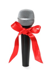 Photo of Microphone with red bow isolated on white. Christmas music