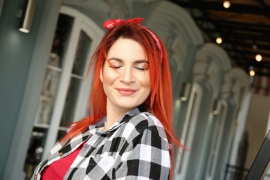 Young woman with bright dyed long hair outdoors