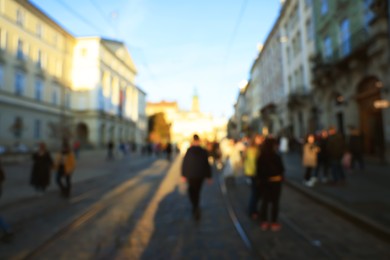 Photo of Blurred view of people walking on city street