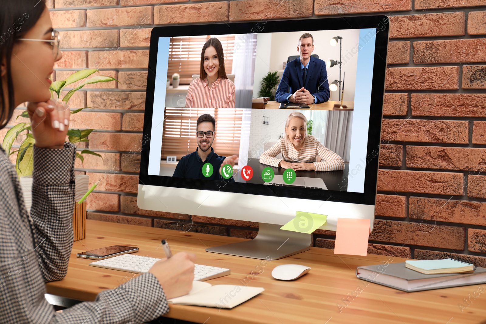 Image of Woman having video chat with colleagues at table in office, closeup. Team work 