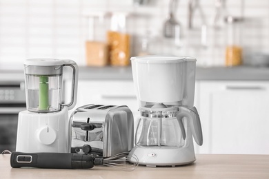 Photo of Kitchen appliances on table against blurred background