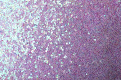 Photo of Beautiful shiny lilac glitter as background, closeup