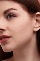 Photo of Portrait of beautiful woman with freckles, closeup