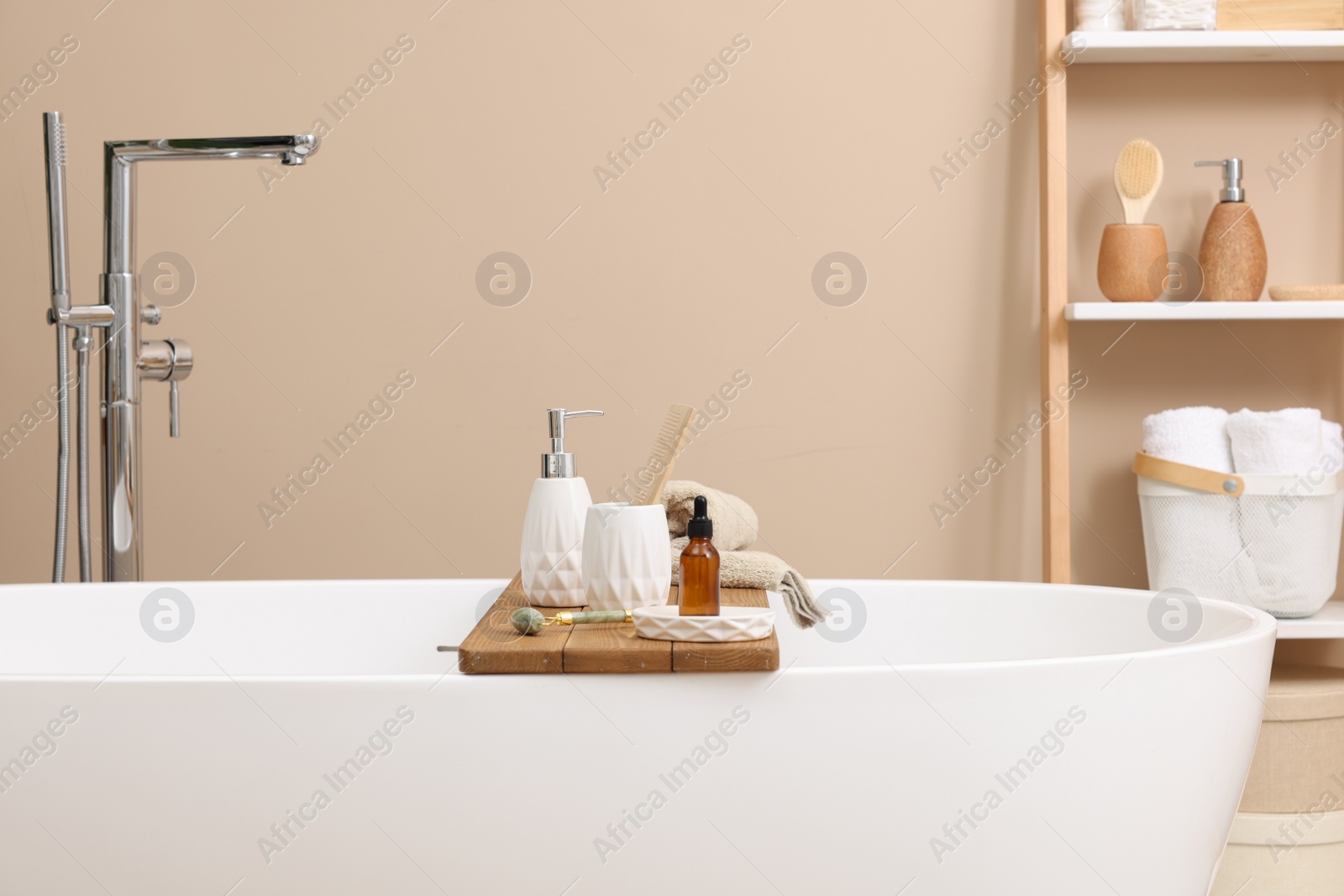 Photo of Different personal care products and accessories on bath tub in bathroom