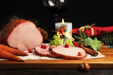 Photo of Delicious ham served on wooden board. Christmas dinner