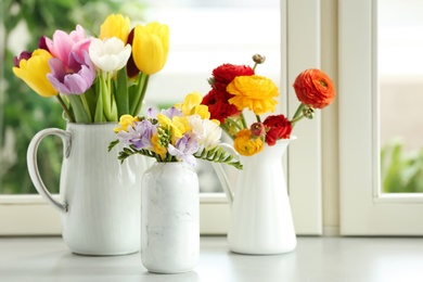 Photo of Different beautiful spring flowers on window sill