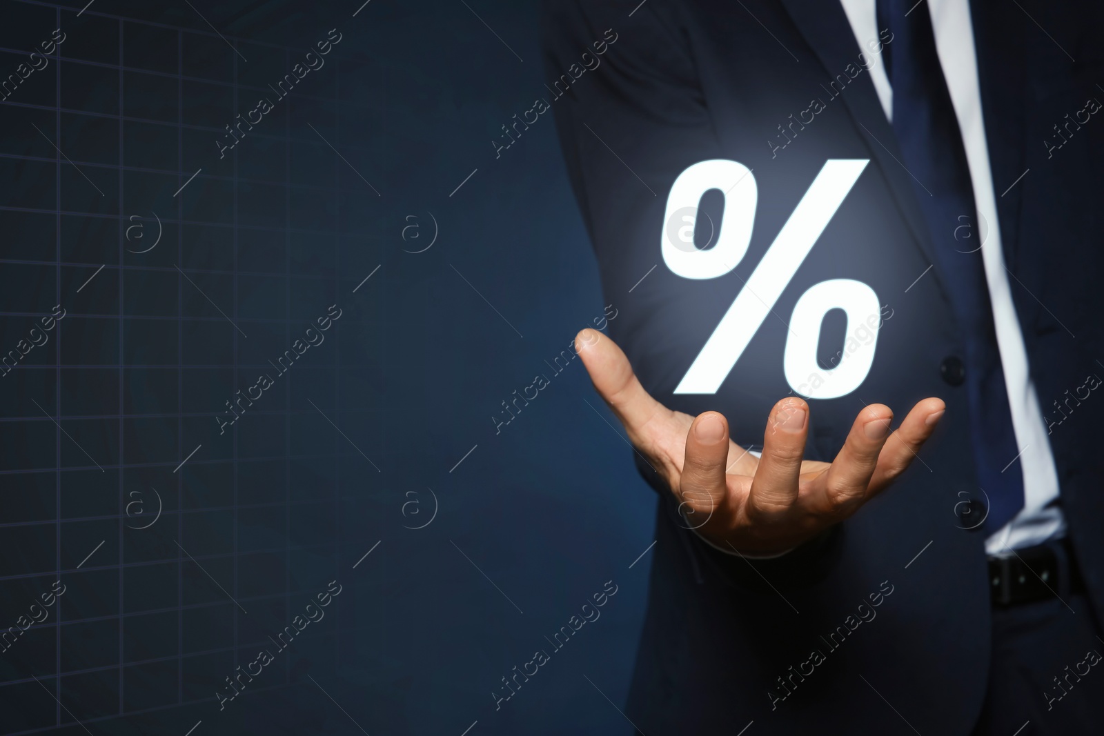 Image of Mortgage. Man holding percent sign on dark blue background, closeup. Space for text