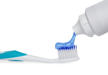 Photo of Applying paste on toothbrush against white background