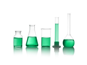 Laboratory glassware with green liquid isolated on white