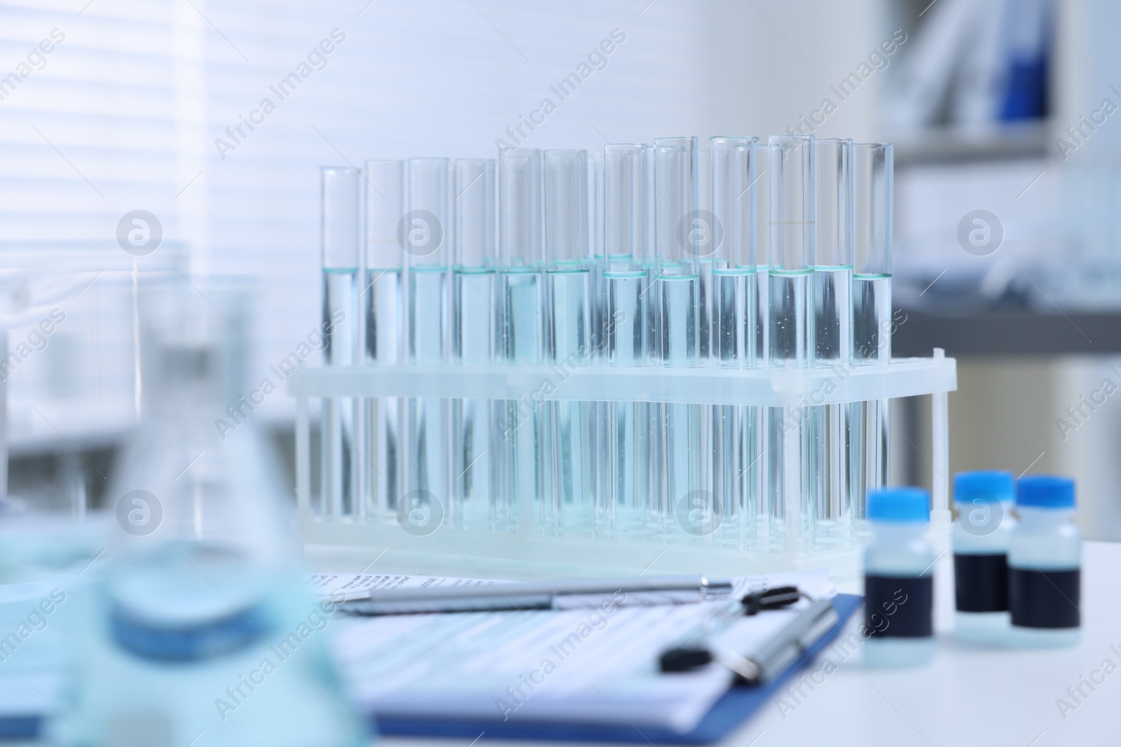 Photo of Test tubes with samples on table in laboratory