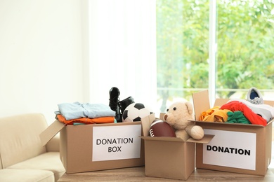 Carton boxes with donations on table indoors