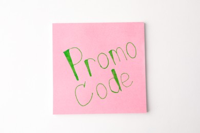 Note with words Promo Code on white background, top view