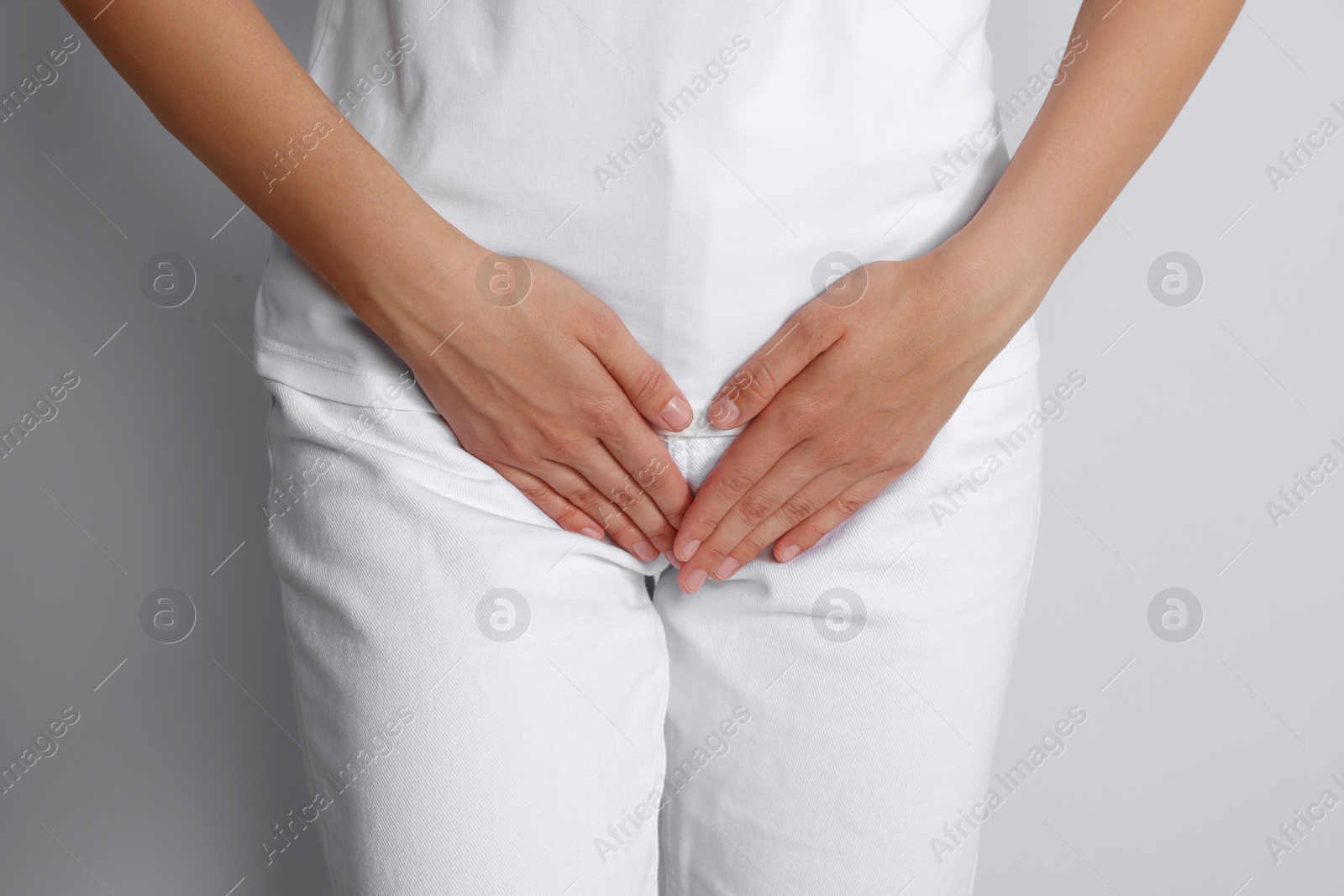 Photo of Woman suffering from herpes genital on grey background, closeup