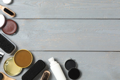 Flat lay composition with shoe care accessories on wooden background, space for text