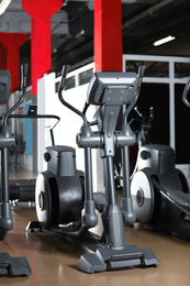 Photo of Elliptical trainer in gym. Modern sport equipment