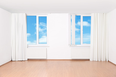 Beautiful view on blue sky with clouds through windows in room