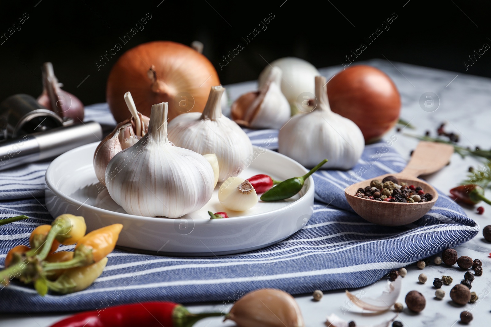 Photo of Composition with onion, garlic and pepper on kitchen table