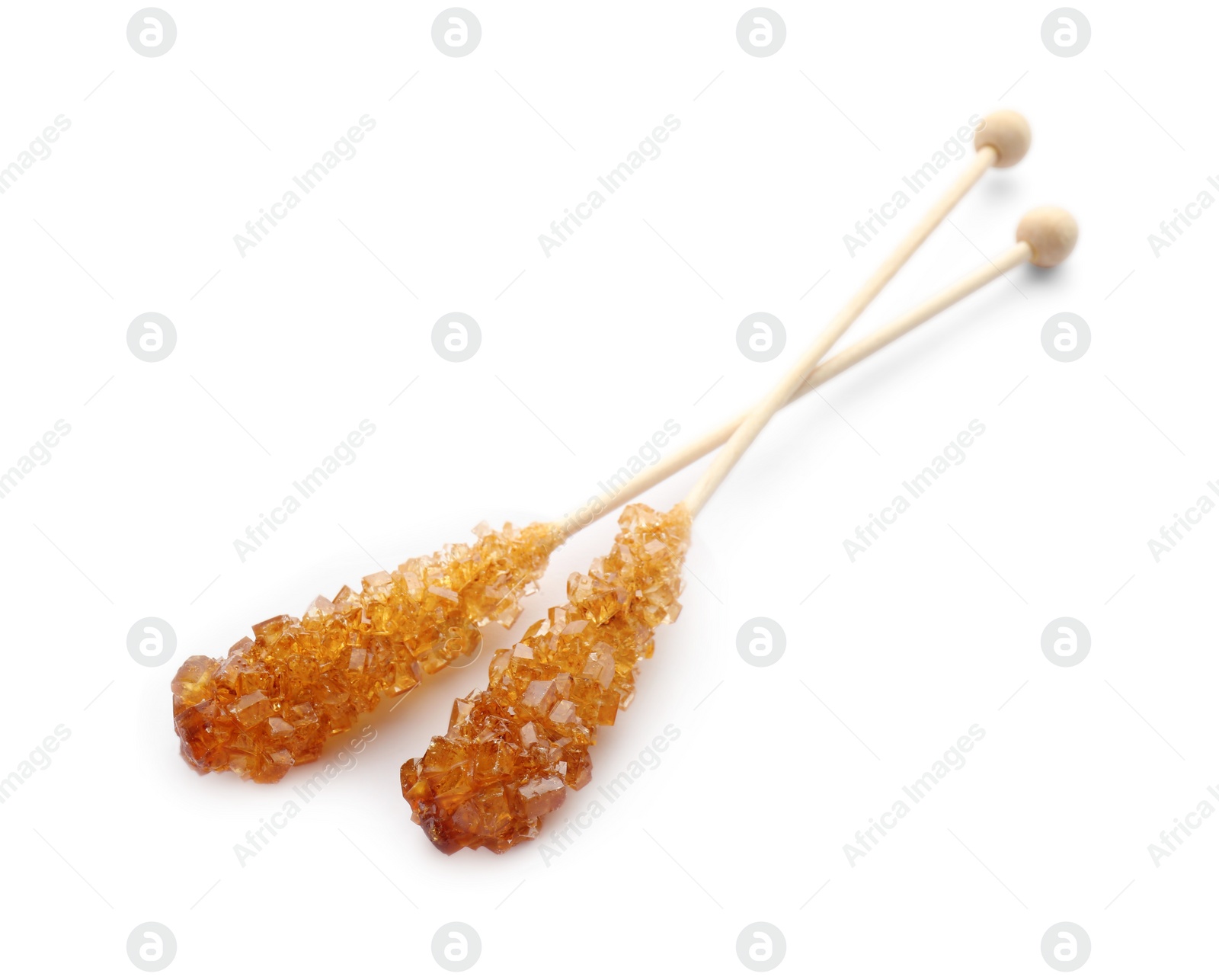 Photo of Wooden sticks with sugar crystals isolated on white. Tasty rock candies