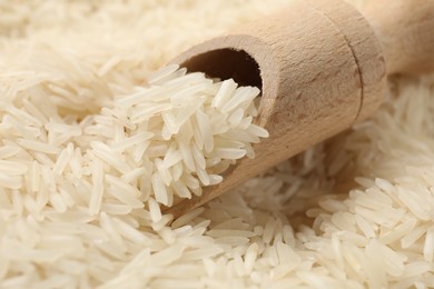 Photo of Raw basmati rice and wooden scoop, closeup