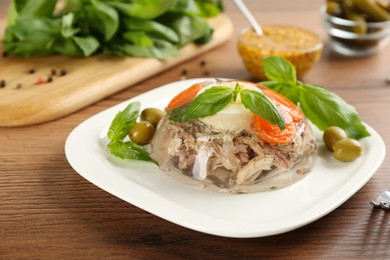 Photo of Delicious aspic with meat served on wooden table