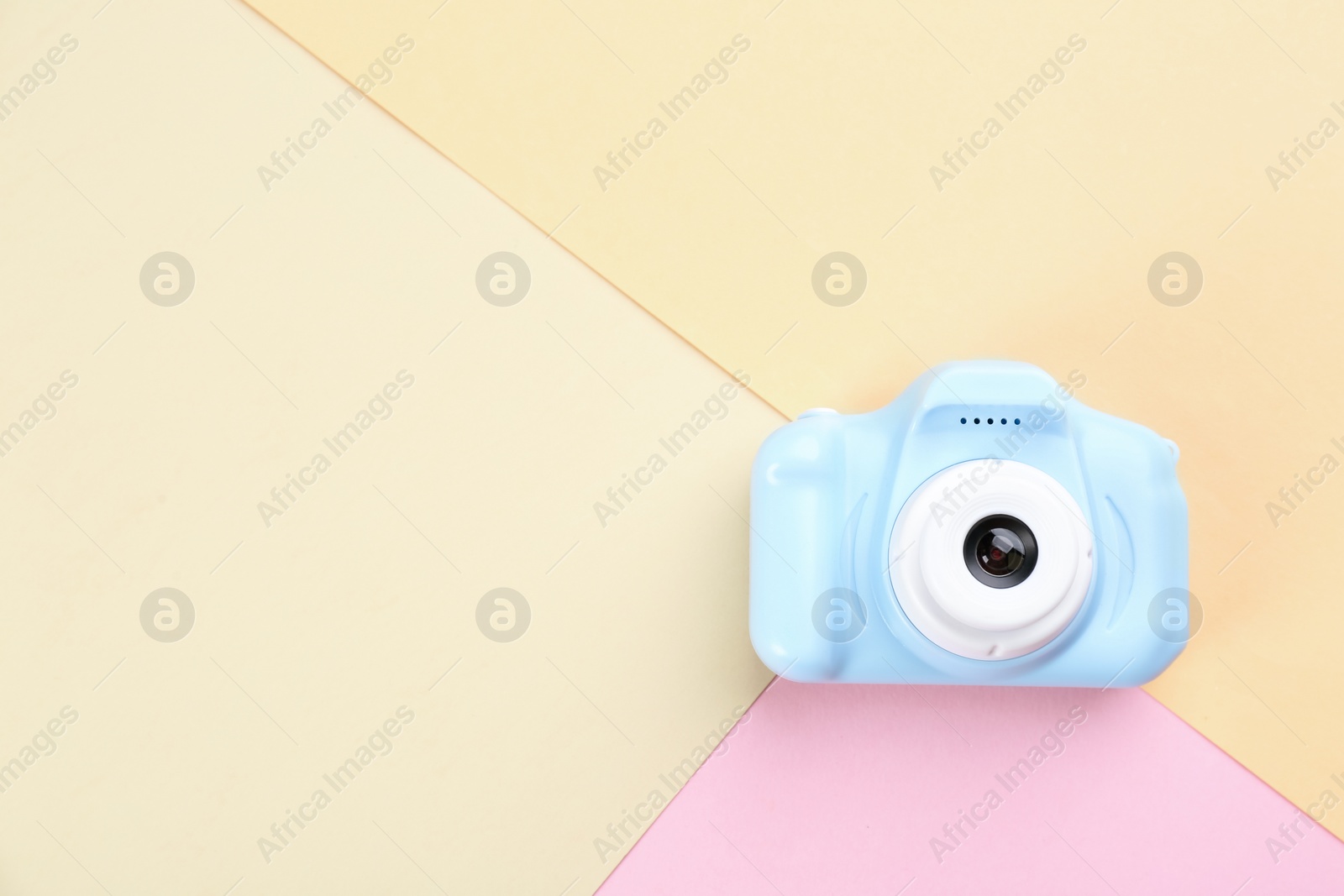 Photo of Light blue toy camera on color background, top view. Space for text