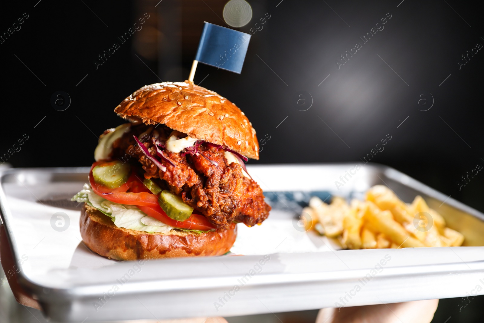 Photo of Tray with delicious burger and french fries on dark background. Space for text