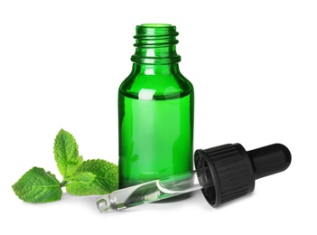 Little bottle of essential oil with dropper and mint on white background
