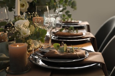 Photo of Festive table setting with beautiful floral decor indoors
