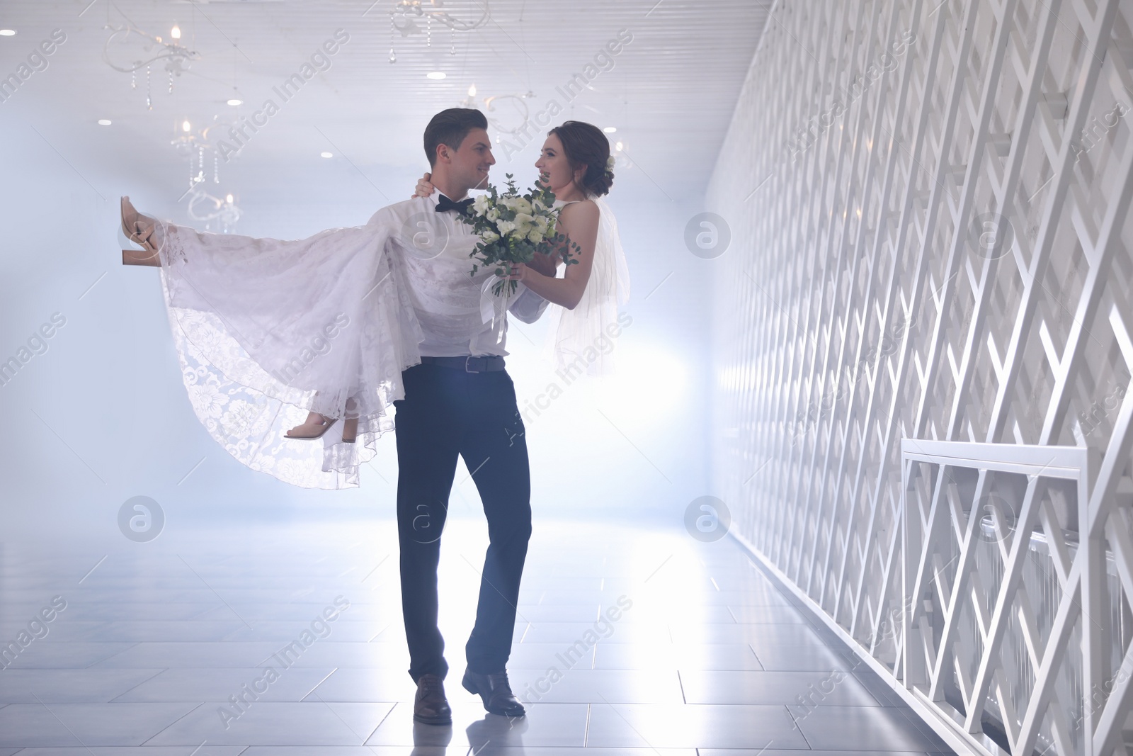 Photo of Happy newlywed couple dancing together in festive hall