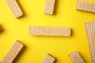 Photo of Flat lay composition with delicious crispy wafers on yellow background